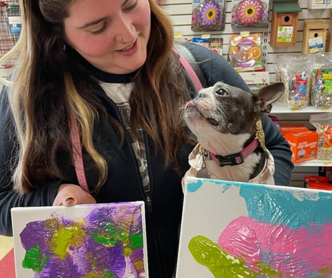 A dog and her owner with their creations